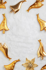 New Year frame, shiny Christmas ornaments gold mushrooms and glowing star on white fake fur...