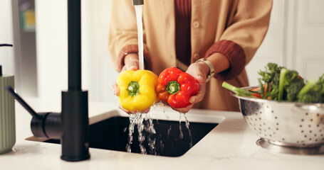 Water, hands and woman in kitchen, vegetables and cleaning with nutrition, washing and wellness. Vegan, home and person with natural ingredients, healthy and bell pepper for food hygiene and cooking
