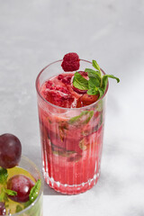 Raspberry mint lemonade, bright overhead composition with textured ice and fresh garnish