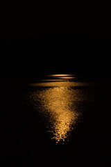 Shimmering orange glow of a moonrise on Mountainview Lake.