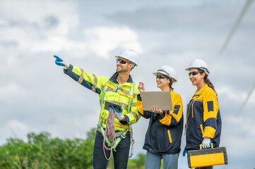 Team of Engineers Planning Project for Renewable Energy Professional Team Inspecting Wind Turbines...