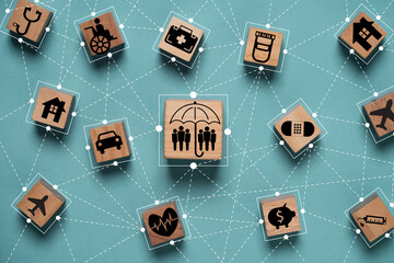 Wooden blocks with various icons representing services and sectors such as healthcare  transportation and finance  connected by lines on a teal background. It symbolizes of insurance concept.