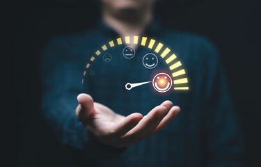 Customer evaluation indicator rating on businessman hand since low to high with smiley face for client customer satisfaction after use product and service  concept.
