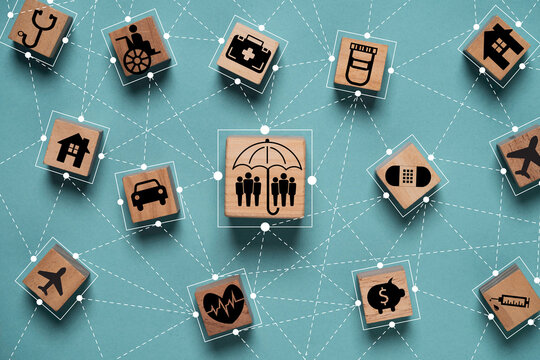 Wooden blocks with various icons representing services and sectors such as healthcare  transportation and finance  connected by lines on a teal background. It symbolizes of insurance concept. - Powered by Adobe