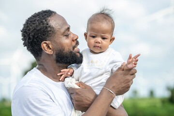 Man is kissing a baby