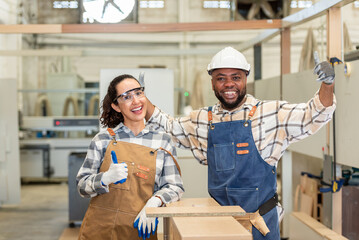 Two confident young carpenter teamwork coworker colleague standing look at camera and smile in...