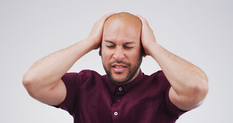 Pain, headache and man in studio with stress, frustrated or financial crisis with fail. Tension...