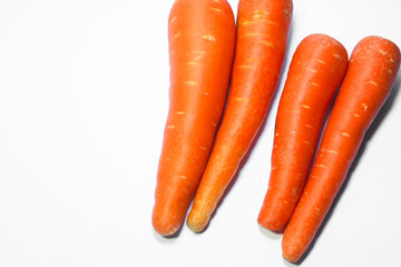 Fresh organic carrots stacked on a clean white background. A healthy root vegetable rich in vitamin A, perfect for cooking, juicing, or raw consumption.