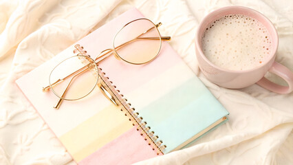 Cozy Aesthetic Featuring Pastel Notebook, Gold Glasses, and Frothy Drink on a Cream Knit Blanket