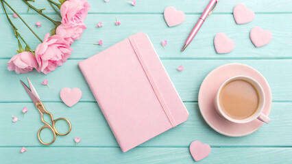 Delicate Pink Still Life Composition with Flowers, Coffee, and Stationery on a Teal Wooden Surface