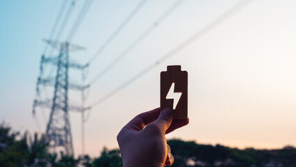 Wooden energy signs with large electric pole in the background, concept of electricity bills,...