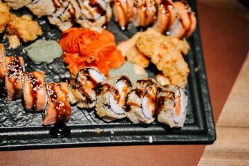 Fresh sushi platter featuring a variety of rolls with vibrant garnishes served at dinner