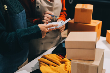 Portrait of Starting small businesses SME owners, two Asian woman check online orders Selling products working with boxs freelance work at home office, sme business online small medium enterprise