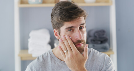 Portrait, cream and skincare with man in bathroom for beauty, morning routine and cosmetics. Self...