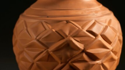 Close up view of intricately designed terracotta vase showcasing geometric patterns ideal for showcasing decorative pottery and artisan craftsmanship - Powered by Adobe
