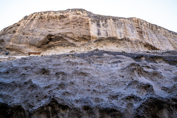 Limestone mountains with grottos against the sky.