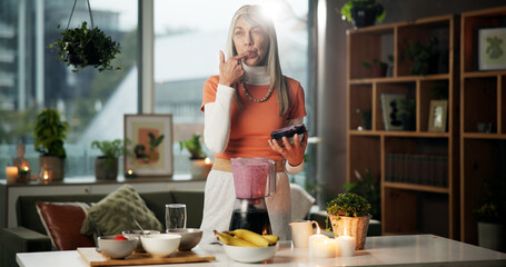 Smoothie, taste and mature woman with blender for healthy gut, benefits and wellness in kitchen....