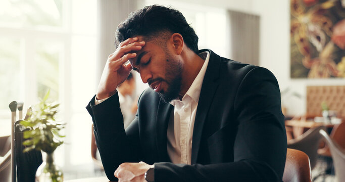 Stress, headache and business man in airport lounge for overbooked flight, jet lag and fatigue. Travel anxiety, schedule crisis and tired with frustrated person for departure delay and ticket error