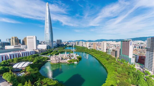 Zoom in Songpa-gu, Jamsil, Seoul, South Korea - July 12, 2025: Aerial view of villas and apartment againsts with Lotte World and Lotte World Tower near Seokchon Lake