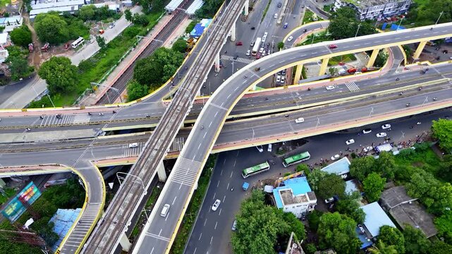 Drone shot overlapping flyover across pune metro cityscape