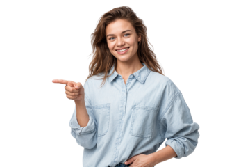 Smiling woman in denim shirt pointing left, confidently presenting or directing, isolated on transparent background