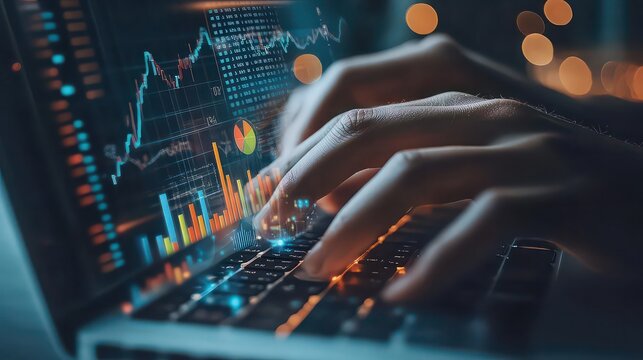 Hands typing on laptop with stock market data displayed on screen in a blurred background setting