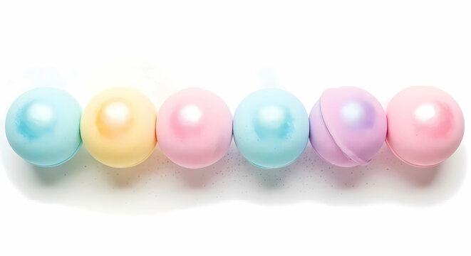 A row of colorful pastel bath bombs isolated on a white background