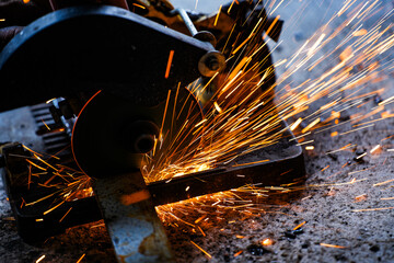 cutting a steel plate with an electric cutting wheel at a factory