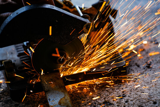 cutting a steel plate with an electric cutting wheel at a factory