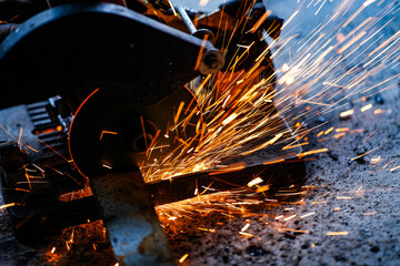 cutting a steel plate with an electric cutting wheel at a factory