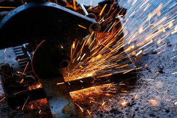 cutting a steel plate with an electric cutting wheel at a factory