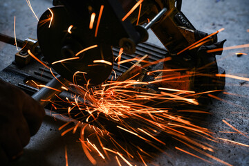 cutting a steel plate with an electric cutting wheel at a factory