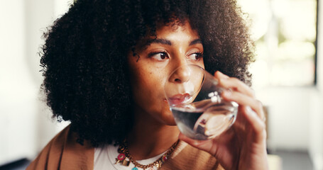 Home, woman and drinking water for health, wellness or benefits for diet. Thirsty African person,...