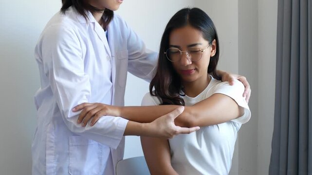 Asian female patient undergoing physical therapy with a physical therapist after suffering from prolonged and intolerable pain. She underwent pain management in a hospital.