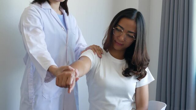 Asian female patient undergoing physical therapy with a physical therapist after suffering from prolonged and intolerable pain. She underwent pain management in a hospital.
