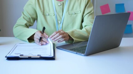 Asian businesswoman employer sitting holding new employee's documents to evaluate and review new employee's personal history. Recruitment concept, job placement.