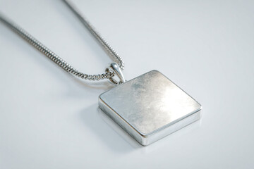 A photorealistic silver necklace with minimalism-inspired square pendant