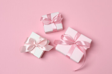 gift boxes, hearts on pink background with space for text