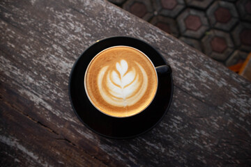 Close up of Hot cappuccino latte with latte art milk foam in cup mug
