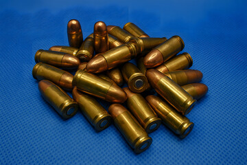 Pile of 9mm Luger ammunition rounds for military, defense, tactical, or firearm-related visuals