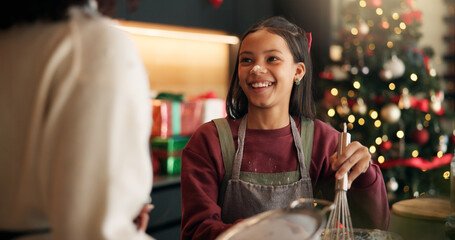 Christmas, parent or girl baking with smile in kitchen for festive tradition, recipe or food. Learning, happy or female child in apartment for holiday celebration, cooking or xmas meal prep in home
