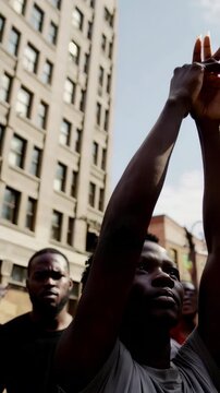 Crowd raising hands in protest