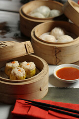 
A tempting spread of various dim sum, including Siu Mai and Har Gow, presented in traditional...