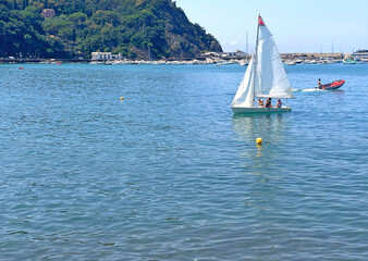 Sestri Levante, Italy - July 15, 2025. Sailboats in sea. Sport and sailing school for teenagers and adults. Nature and vacation in Italy. Leisure and seasons.