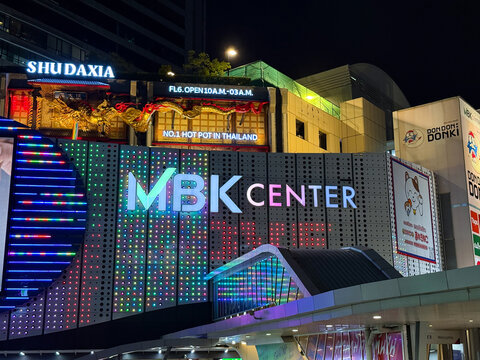 Bangkok, Thailand - June 20, 2025: Close-up of MBK shopping Center LED lights and storefront signs at night