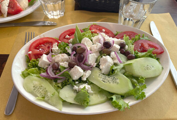 Greek salad of tomatoes, bryndza cheese, cucumbers. Food and health. Mediterranean diet.