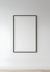 Empty black framed picture on a white wall in a modern interior setting. Blank canvas art display in a minimalist home.