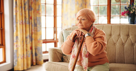 Walking stick, memory and senior woman in home with thinking, retirement or remember nostalgia....