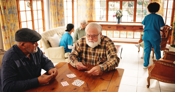 Elderly men, friends and playing cards in homecare for contest, friendly competition and hobby. Senior people, game bet and challenge for retirement entertainment, cognitive activity and nursing home - Powered by Adobe