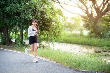 Portrait of beautiful asian Young woman in white robe wearing sportswear jogging working out...